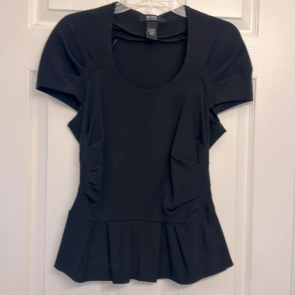 Body by Victoria peplum body contour top. Black, low scoop neck, size M